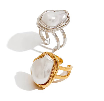 Two pearl-encrusted rings, one gold and one silver, on a white background.